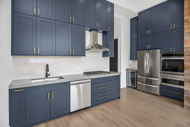 a kitchen with a sink cabinets and stainless steel appliances