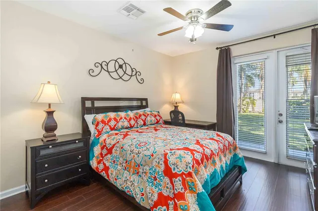 a bedroom with a bed and a lamp on a dresser