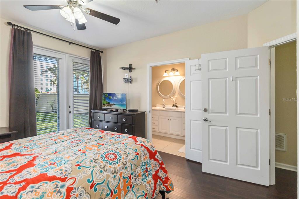 5038 Tideview Circle, Unit 26 Orlando, FL 32819 - Photo 12 of 42 a bedroom with a bed and a dresser in it