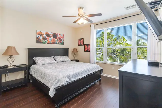 a large bed sitting in a bedroom next to a window
