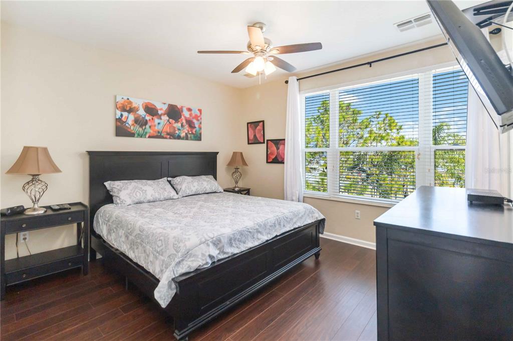 5038 Tideview Circle, Unit 26 Orlando, FL 32819 - Photo 14 of 42 a large bed sitting in a bedroom next to a window