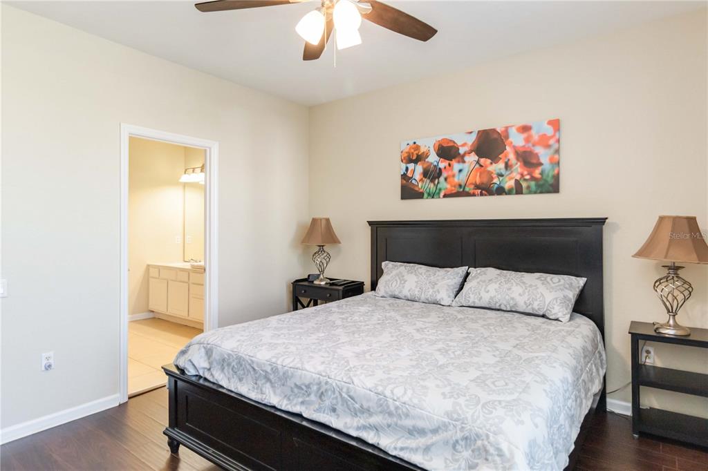 5038 Tideview Circle, Unit 26 Orlando, FL 32819 - Photo 15 of 42 a bedroom with a large bed and a chandelier
