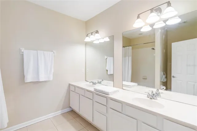 a bathroom with a sink vanity and a mirror