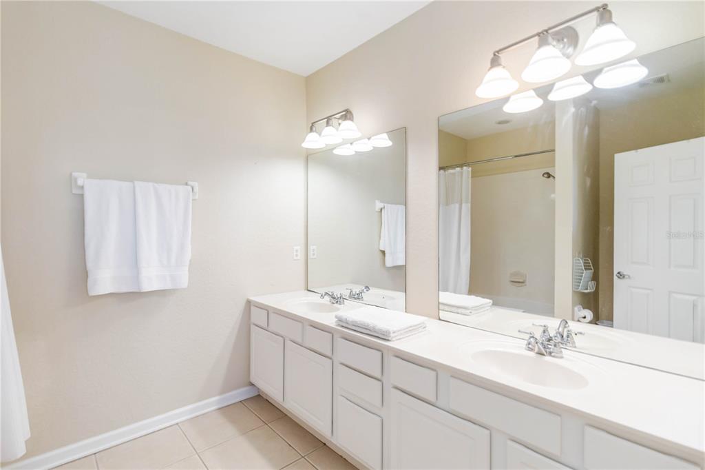 5038 Tideview Circle, Unit 26 Orlando, FL 32819 - Photo 16 of 42 a bathroom with a sink vanity and a mirror