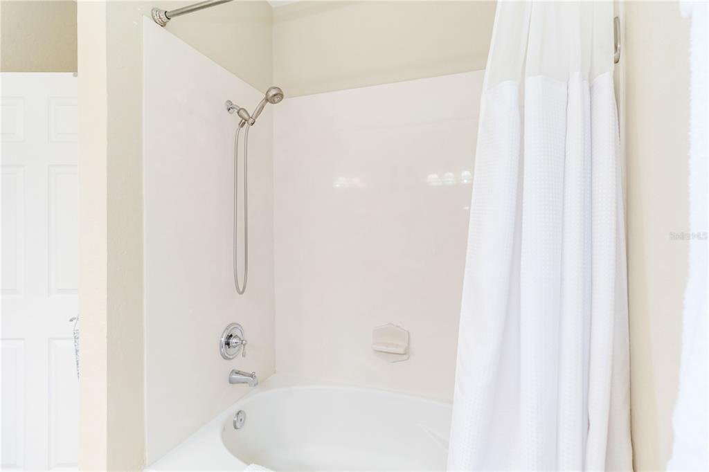 5038 Tideview Circle, Unit 26 Orlando, FL 32819 - Photo 17 of 42 a bathroom with a bathtub and a shower