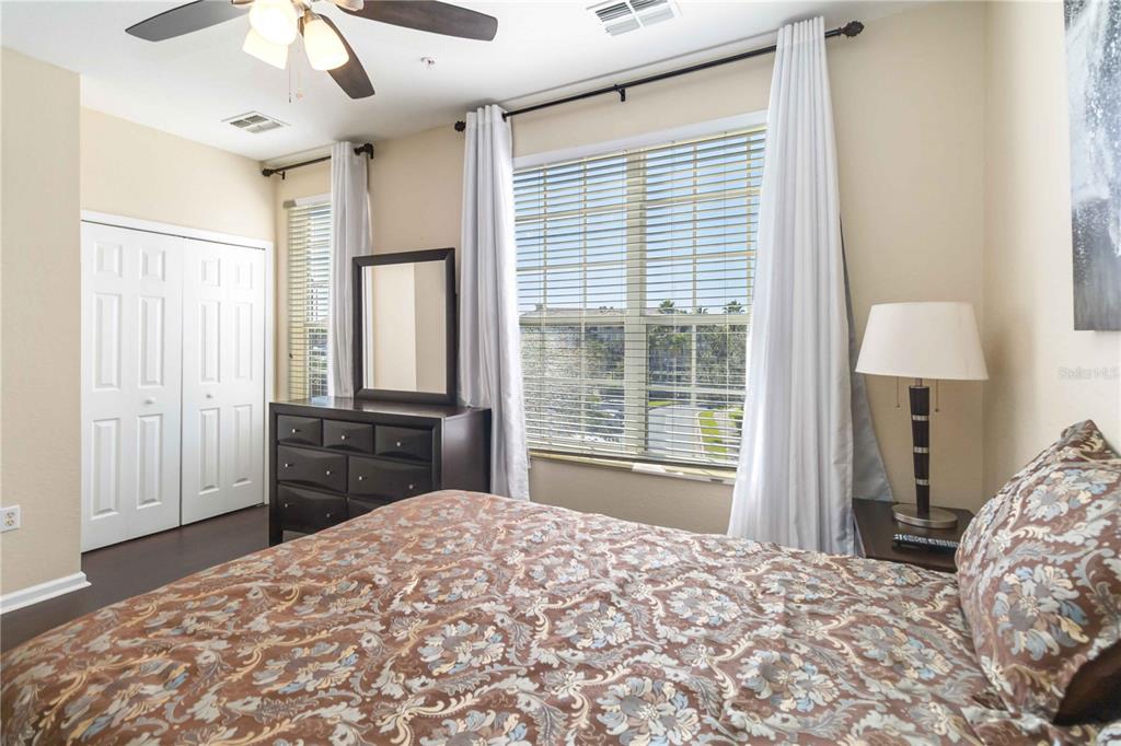 5038 Tideview Circle, Unit 26 Orlando, FL 32819 - Photo 19 of 42 a bedroom with a bed and a large window