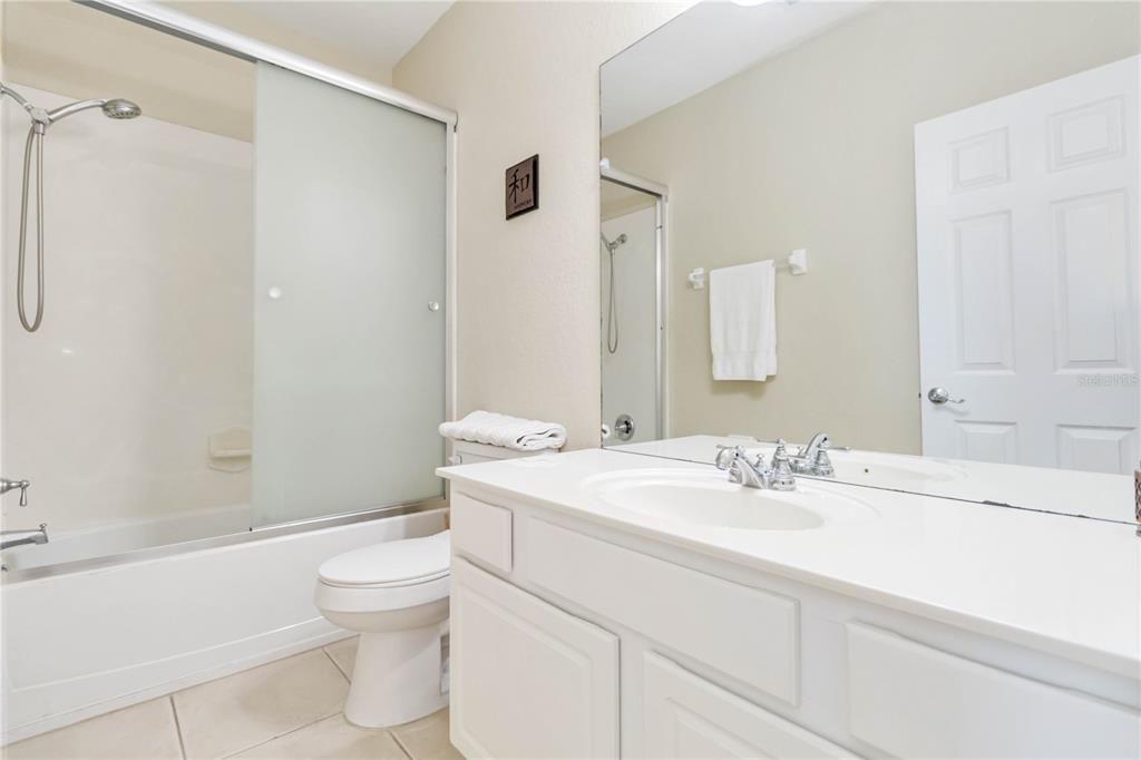 5038 Tideview Circle, Unit 26 Orlando, FL 32819 - Photo 20 of 42 a bathroom with a sink a toilet and shower
