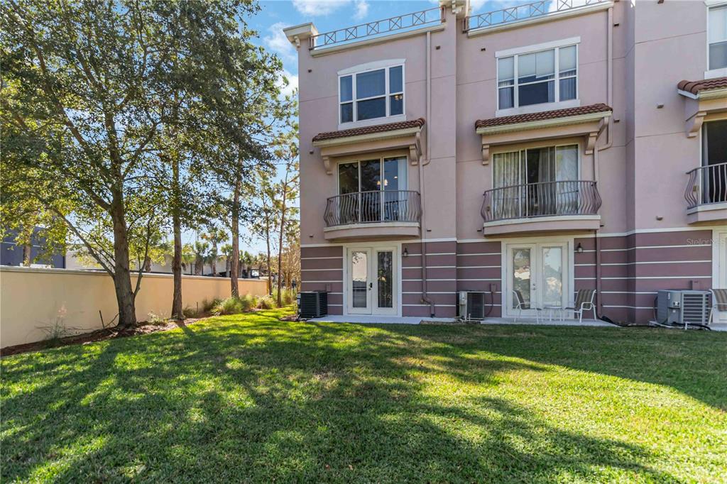 5038 Tideview Circle, Unit 26 Orlando, FL 32819 - Photo 22 of 42 front view of a building with a yard