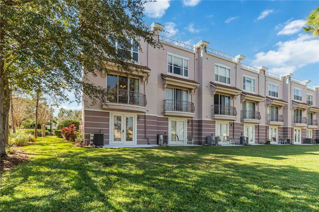 5038 Tideview Circle, Unit 26 Orlando, FL 32819 - Photo 23 of 42 a view of a building with a yard