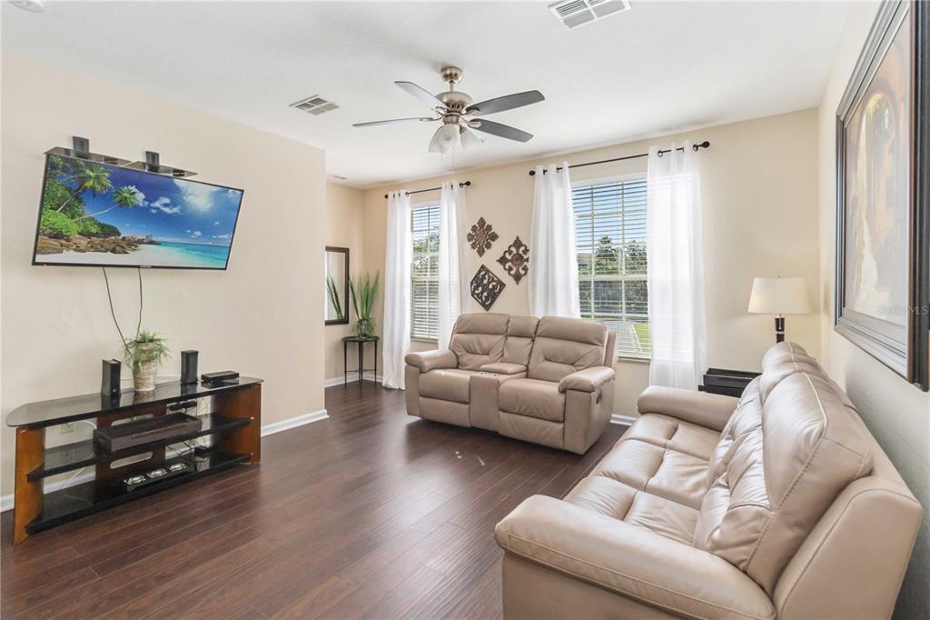 5038 Tideview Circle, Unit 26 Orlando, FL 32819 - Photo 4 of 42 a living room with furniture and wooden floor