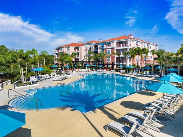 a view of a swimming pool with outdoor seating