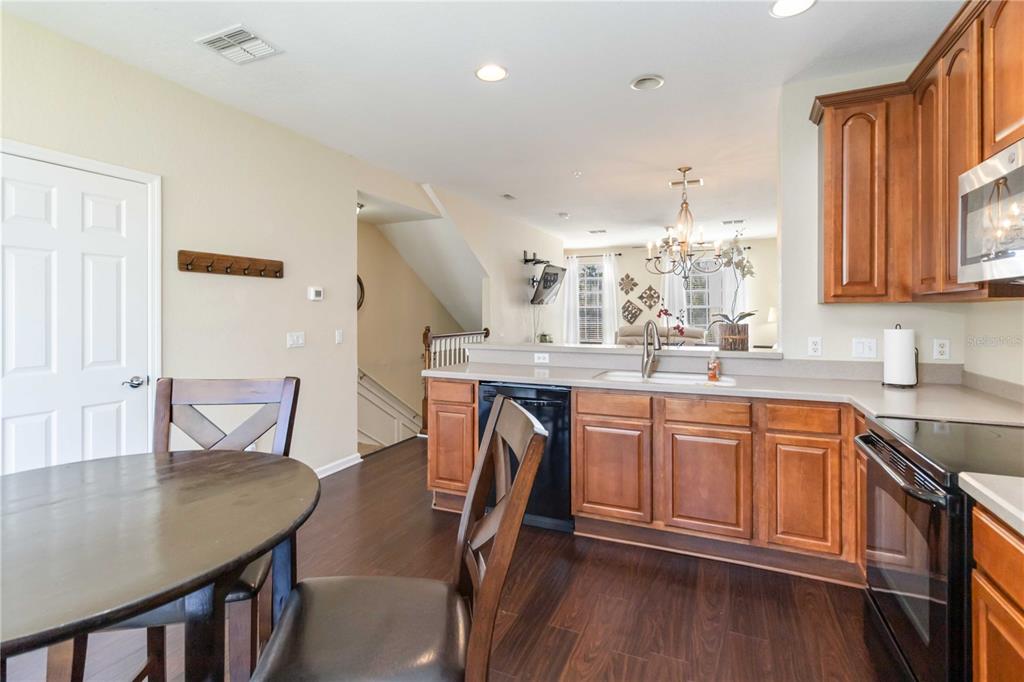 5038 Tideview Circle, Unit 26 Orlando, FL 32819 - Photo 10 of 42 a kitchen with stainless steel appliances granite countertop a kitchen island a stove a table and chairs
