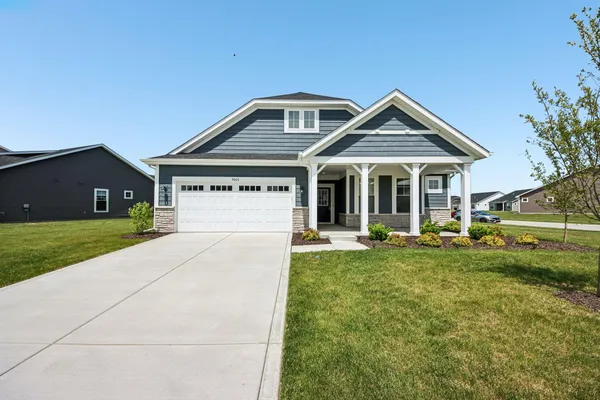 a front view of a house with a yard and porch