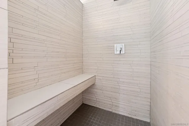 a view of a patio with table and chairs and floor to ceiling window