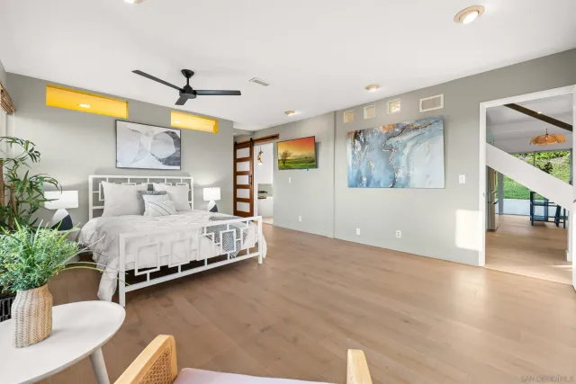 a view of hallway with wooden floor and windows