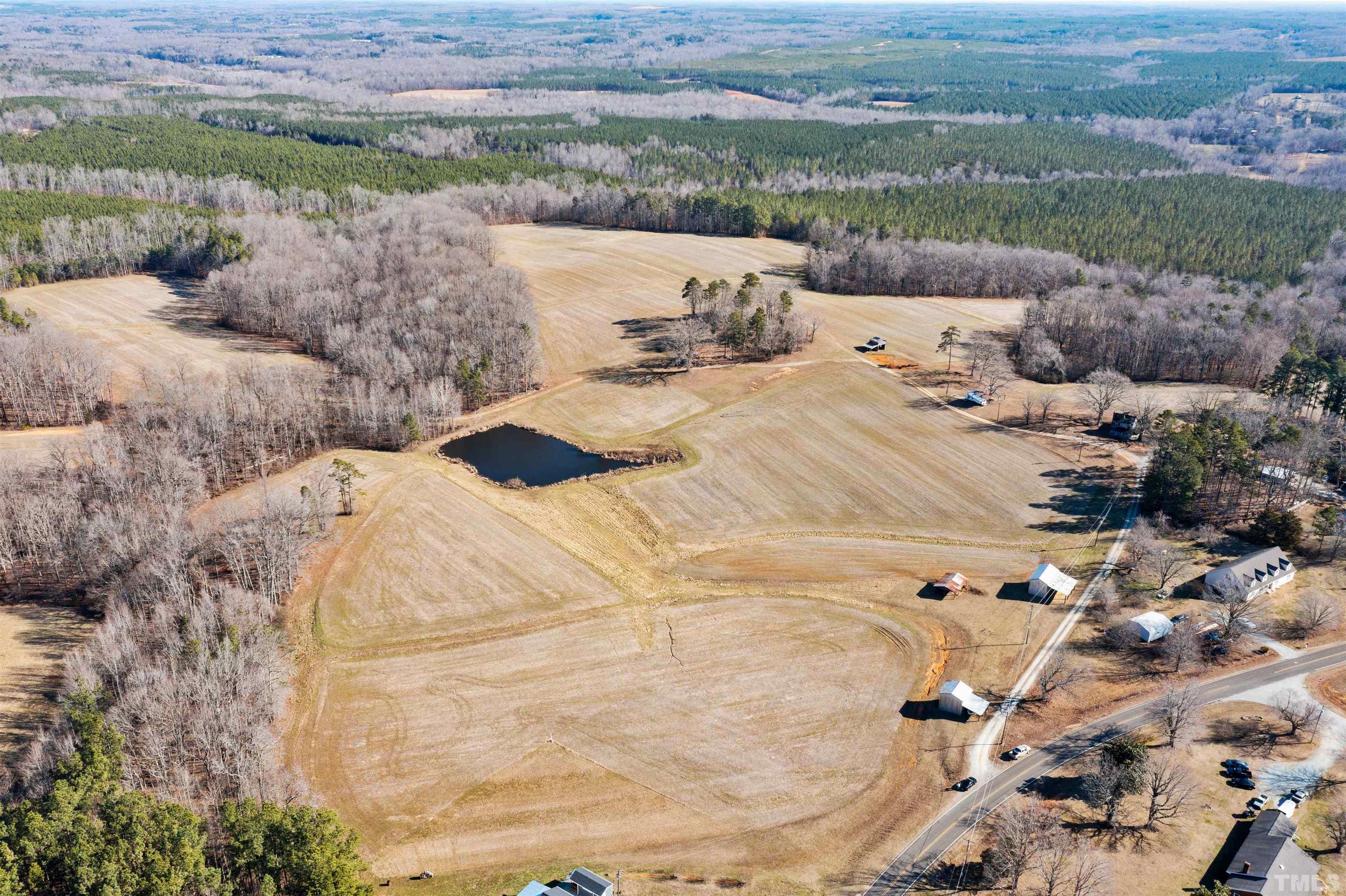 377 Parham Road Roxboro, NC 27574 - Photo 22 of 22 a view of a lake in middle of the field