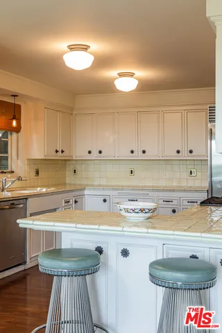 a kitchen with a stove sink and cabinets