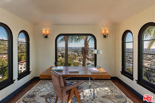 a hallway with wooden floor and furniture
