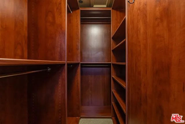 a bathroom with a granite countertop tub sink and mirror