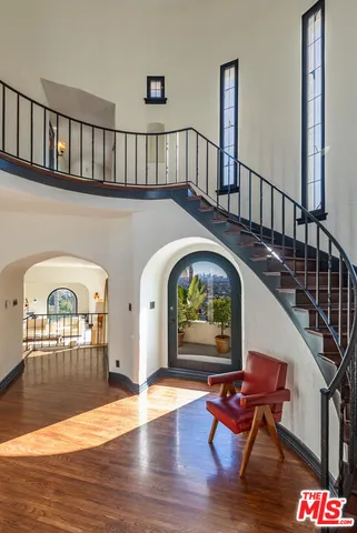 a view of livingroom with furniture staircase and wooden floor