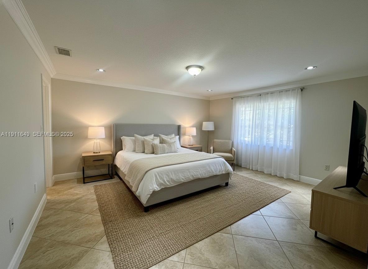 6905 Southwest 148th Court Miami, FL 33193 - Photo 14 of 26 a bedroom with a bed and a television