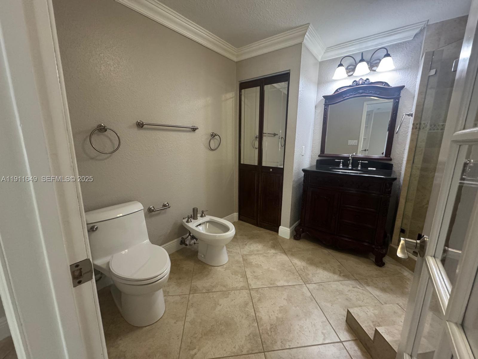 6905 Southwest 148th Court Miami, FL 33193 - Photo 17 of 26 a bathroom with a toilet a sink and mirror