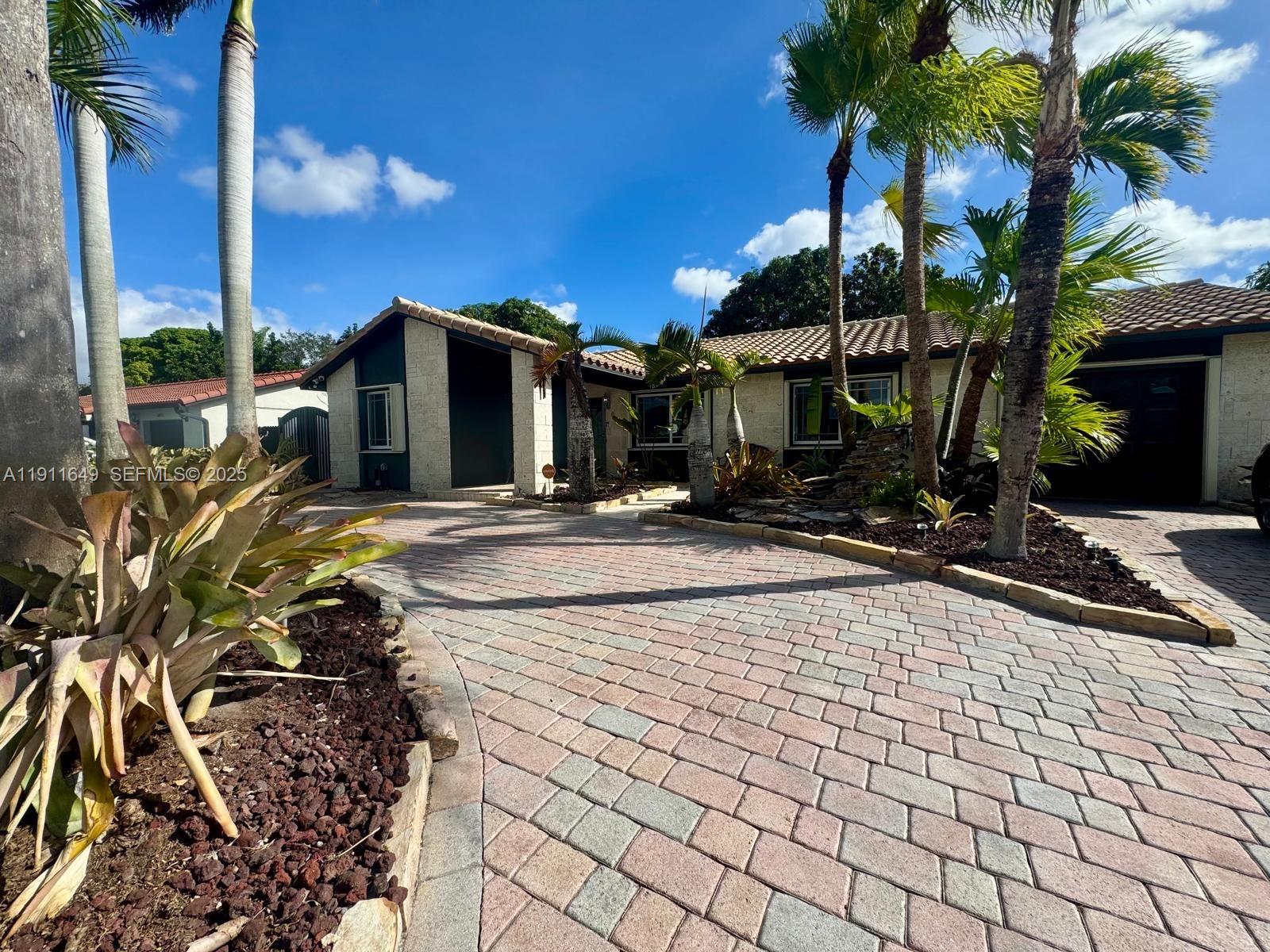 6905 Southwest 148th Court Miami, FL 33193 - Photo 2 of 26 a view of a backyard with palm trees