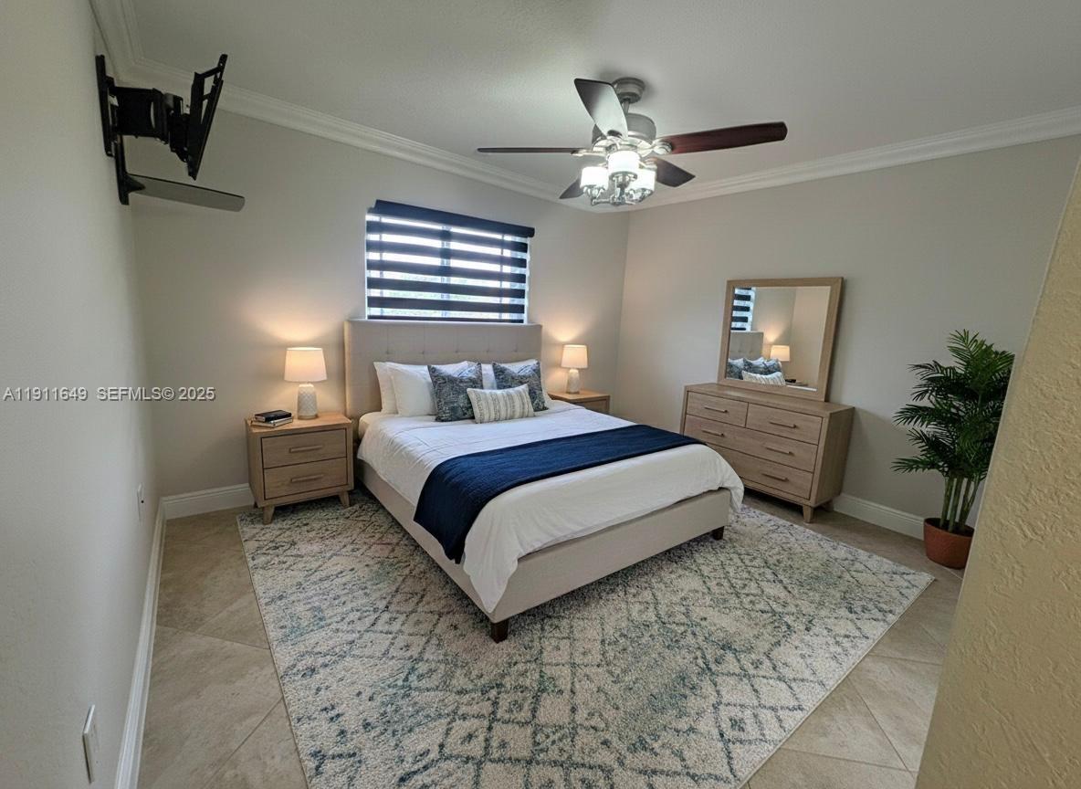 6905 Southwest 148th Court Miami, FL 33193 - Photo 23 of 26 a bedroom with a bed and a chandelier