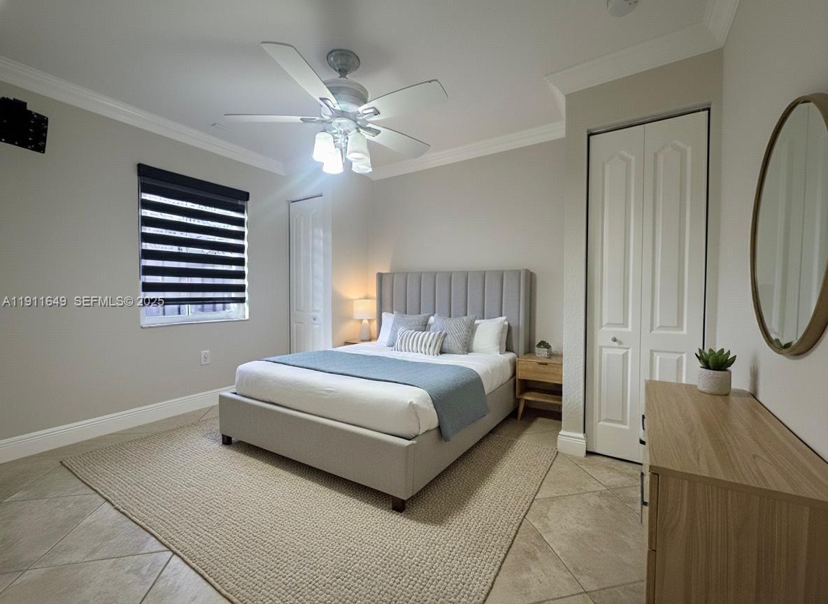 6905 Southwest 148th Court Miami, FL 33193 - Photo 25 of 26 a bedroom with a bed and a chandelier