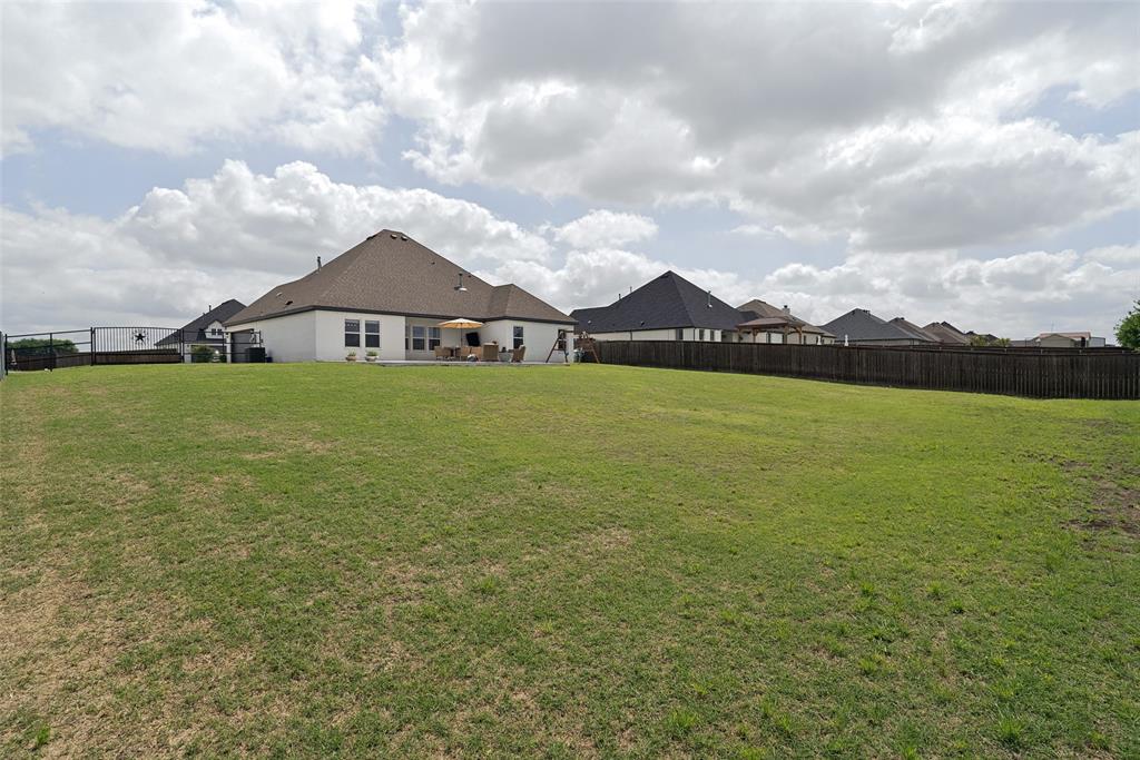 9424 Wildcat Ridge Godley, TX 76044 - Photo 22 of 25 a view of a large garden with plants and large trees