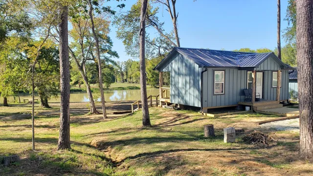 a large bed sitting in a bedroom and a mirror