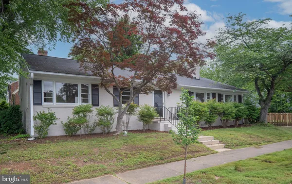 a view of hallway with windows and wooden floor