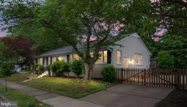an empty room with wooden floor and a ceiling fan