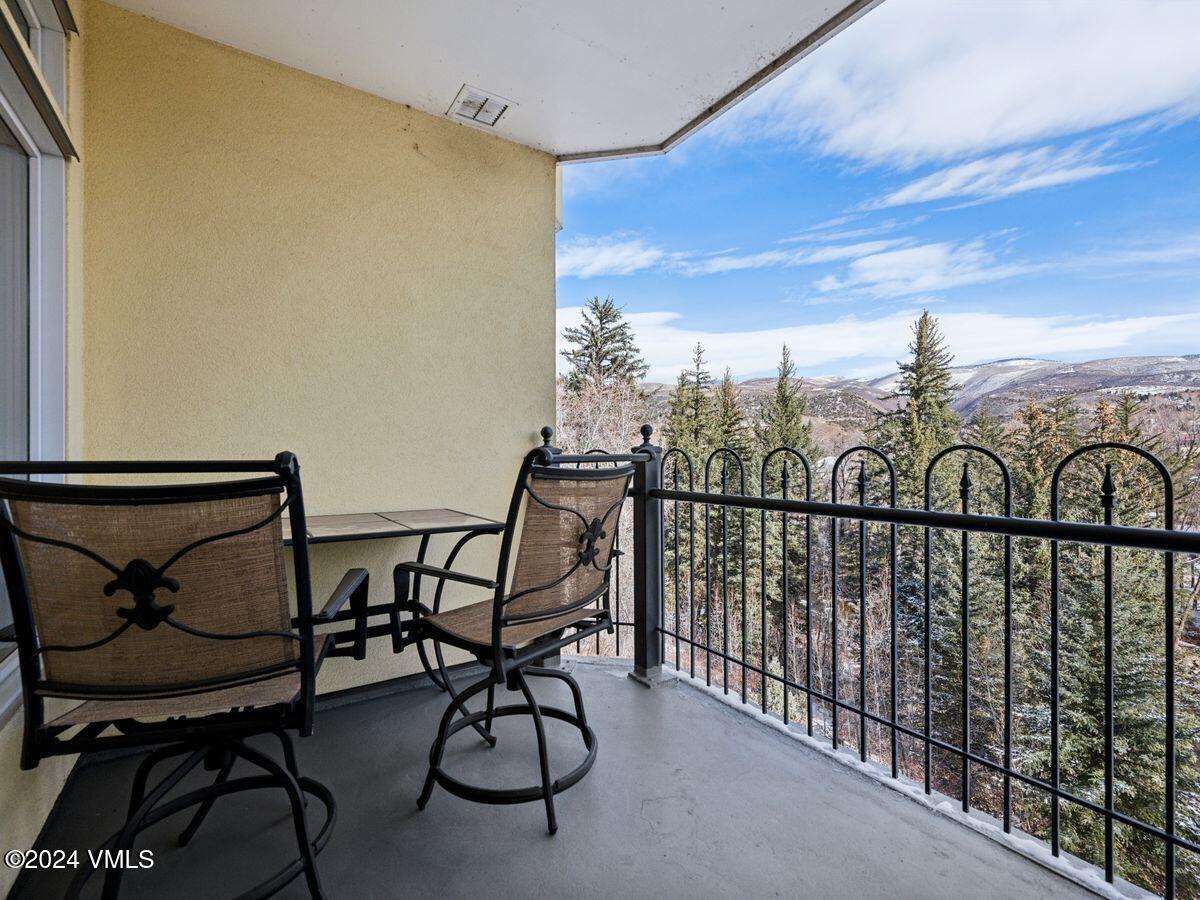 137 Main Street, Unit R203 Edwards, CO 81632 - Photo 13 of 39 a view of a chairs and table in the balcony