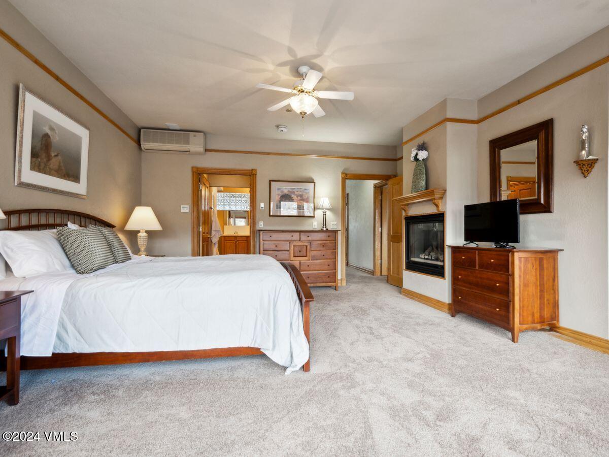 137 Main Street, Unit R203 Edwards, CO 81632 - Photo 20 of 39 a spacious bedroom with a bed and a flat screen tv