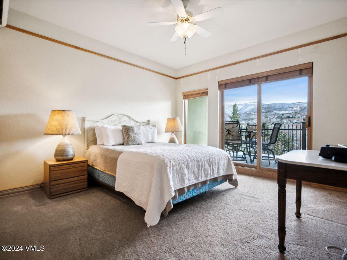 137 Main Street, Unit R203 Edwards, CO 81632 - Photo 27 of 39 a bed room with a bed and a table