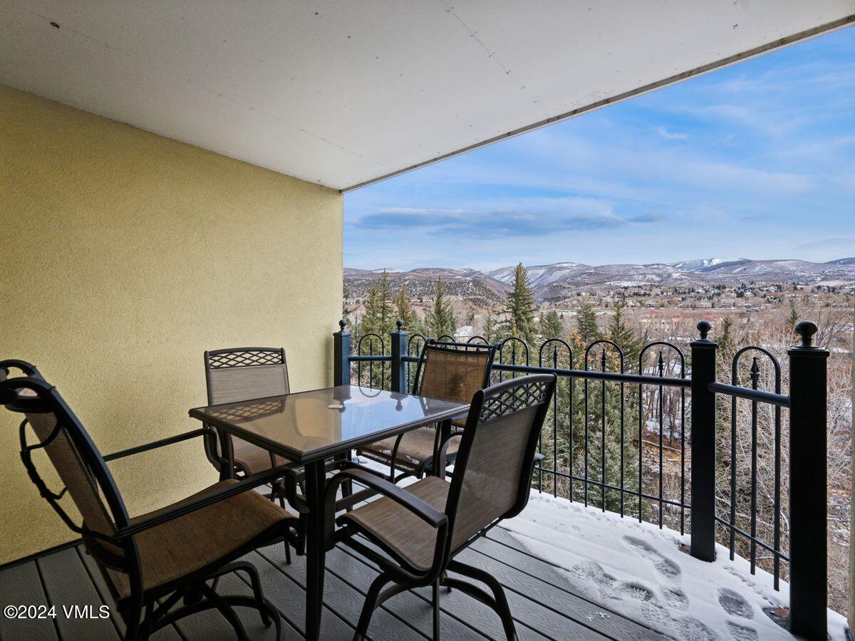 137 Main Street, Unit R203 Edwards, CO 81632 - Photo 30 of 39 a view of a balcony with a table and chairs