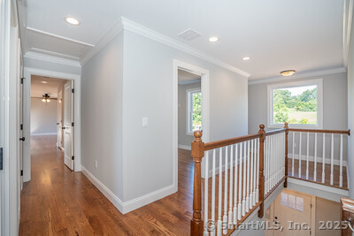 953 High Road Berlin, CT 06037 - Photo 17 of 32 a view of a hallway with wooden floor and windows