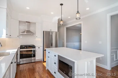 a kitchen with a stove a sink and a refrigerator