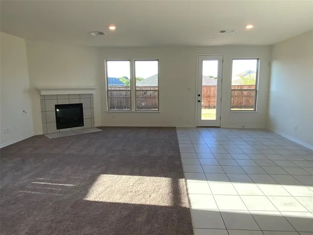 a view of an empty room with glass door and glass door