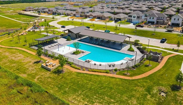 a sign board with building in front of it