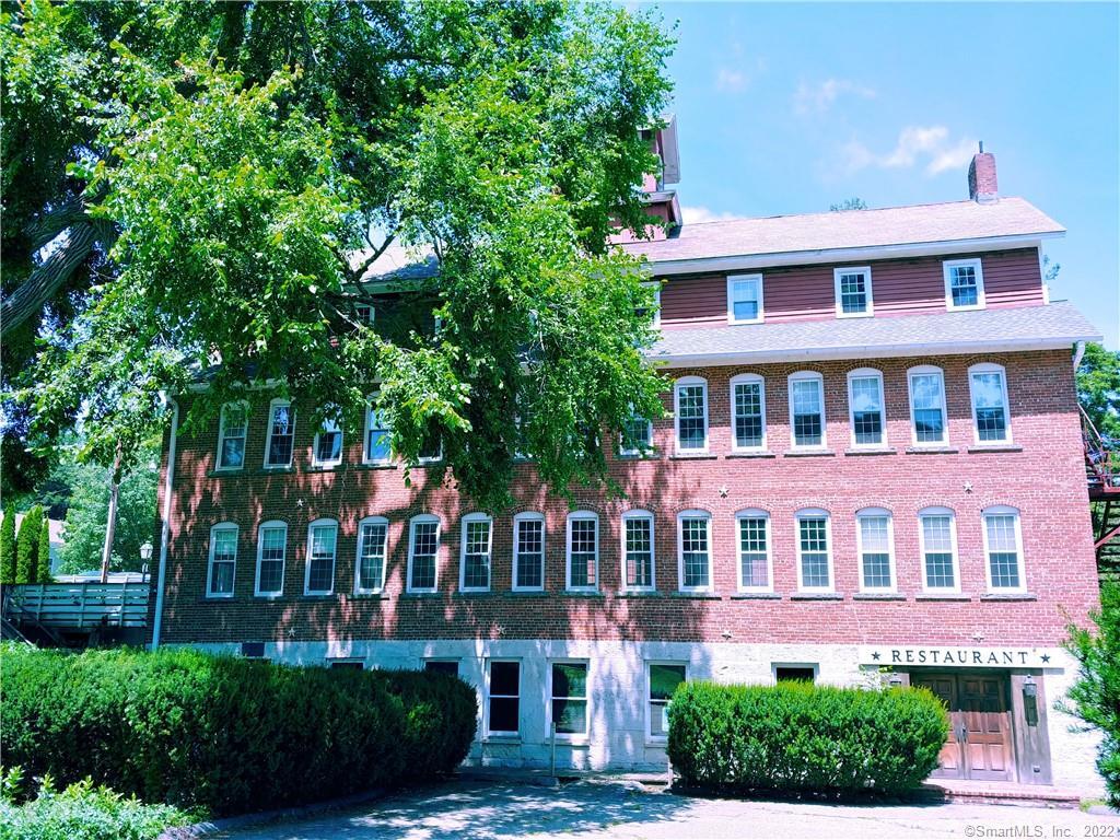 8 Holley Street Salisbury, CT 06039 - Photo 18 of 21 a front view of a building with a garden and plants