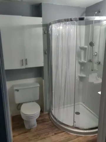a bathroom with a toilet and a shower