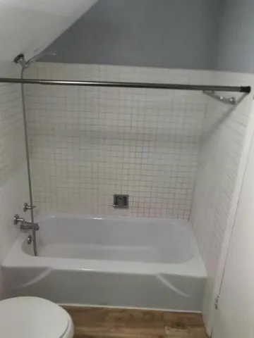 a bathroom with a shower and a toilet