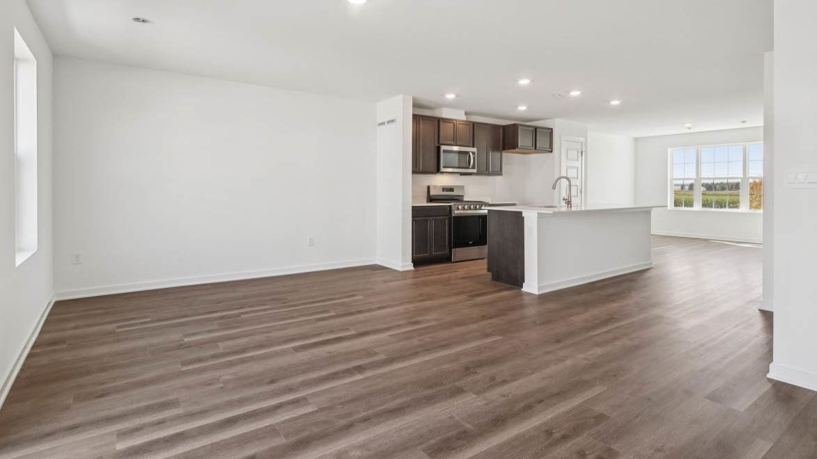 6510 Linden Trail, Unit E Wonder Lake, IL 60097 - Photo 4 of 42 a kitchen with stainless steel appliances kitchen island wooden floors and white walls