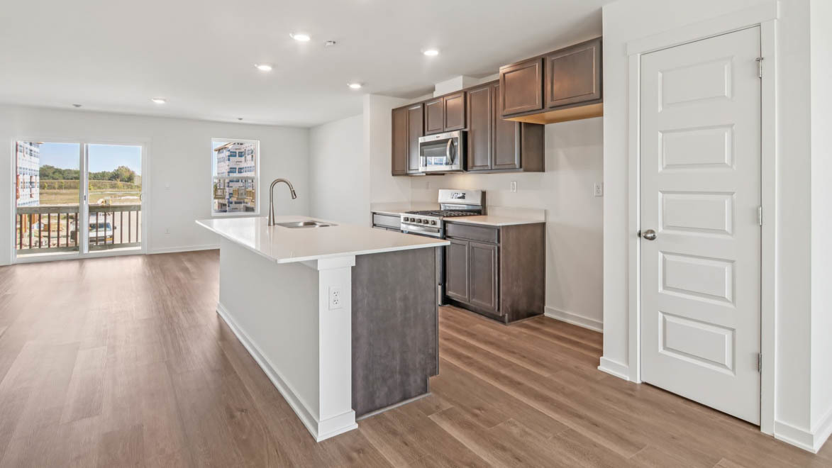 6510 Linden Trail, Unit E Wonder Lake, IL 60097 - Photo 6 of 42 a kitchen with stainless steel appliances granite countertop a refrigerator a stove top oven a sink and dishwasher with wooden floor