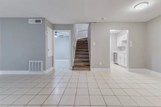 a view of an empty room with stairs and ventilation