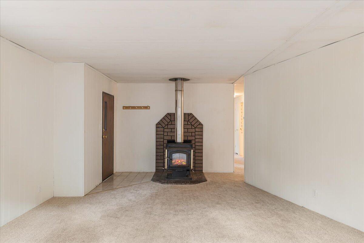 60214 Agate Road Bend, OR 97702 - Photo 6 of 31 Front door and wood-burning fireplace off the living room
