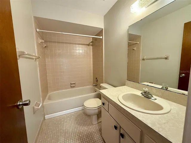 a bathroom with a sink toilet tub and shower