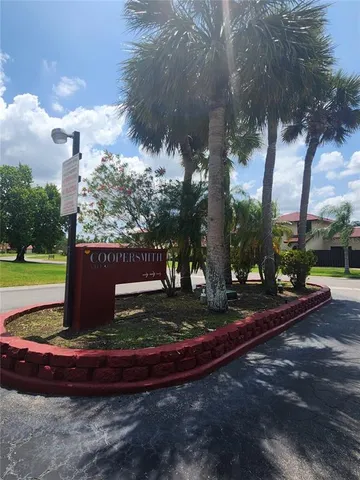 a view of a street with large trees